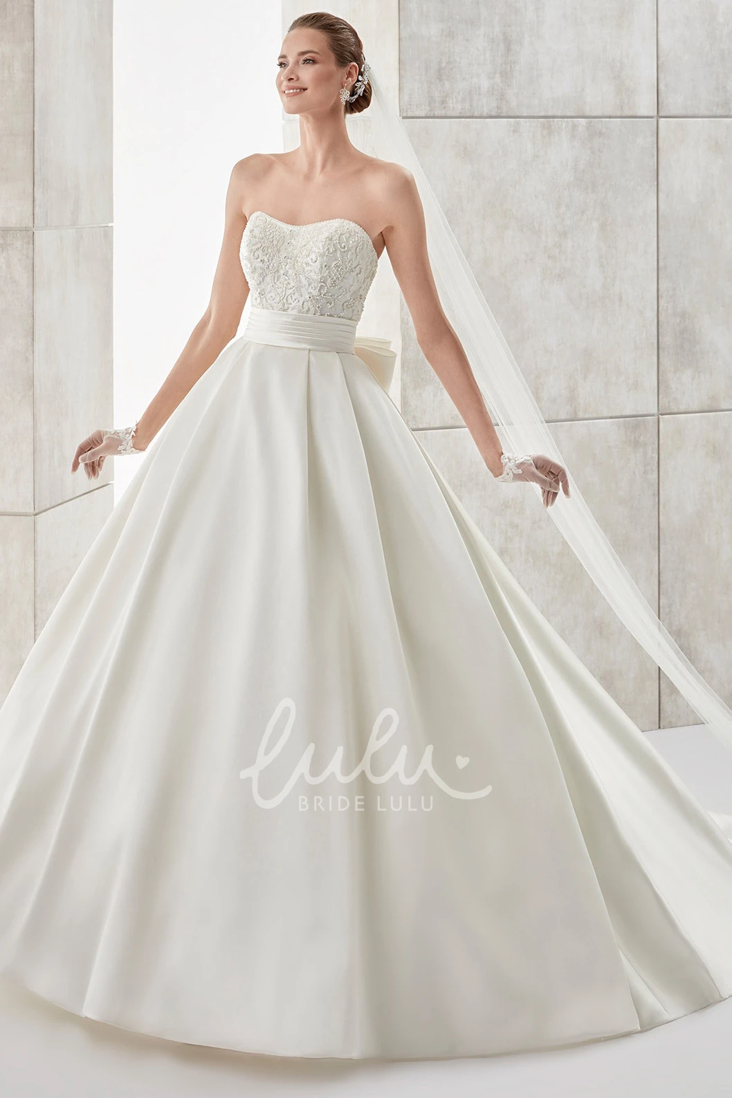 A-line Wedding Dress with Strapless Neckline Cinched Waistband and Back Bow